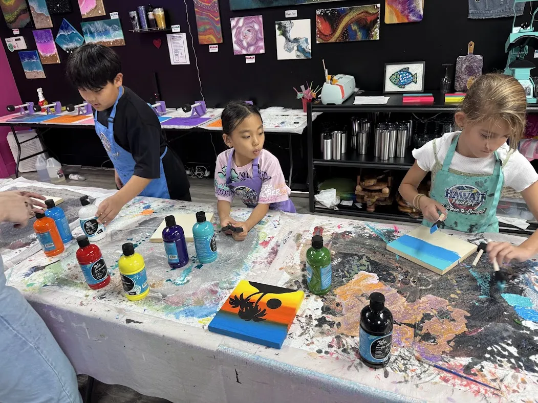 Creative Creators ages 7-9 exploring fluid art and resin crafts in after school art