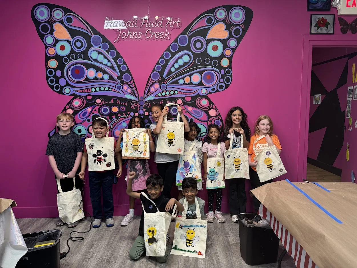 Kids creating colorful art projects during a school break camp session