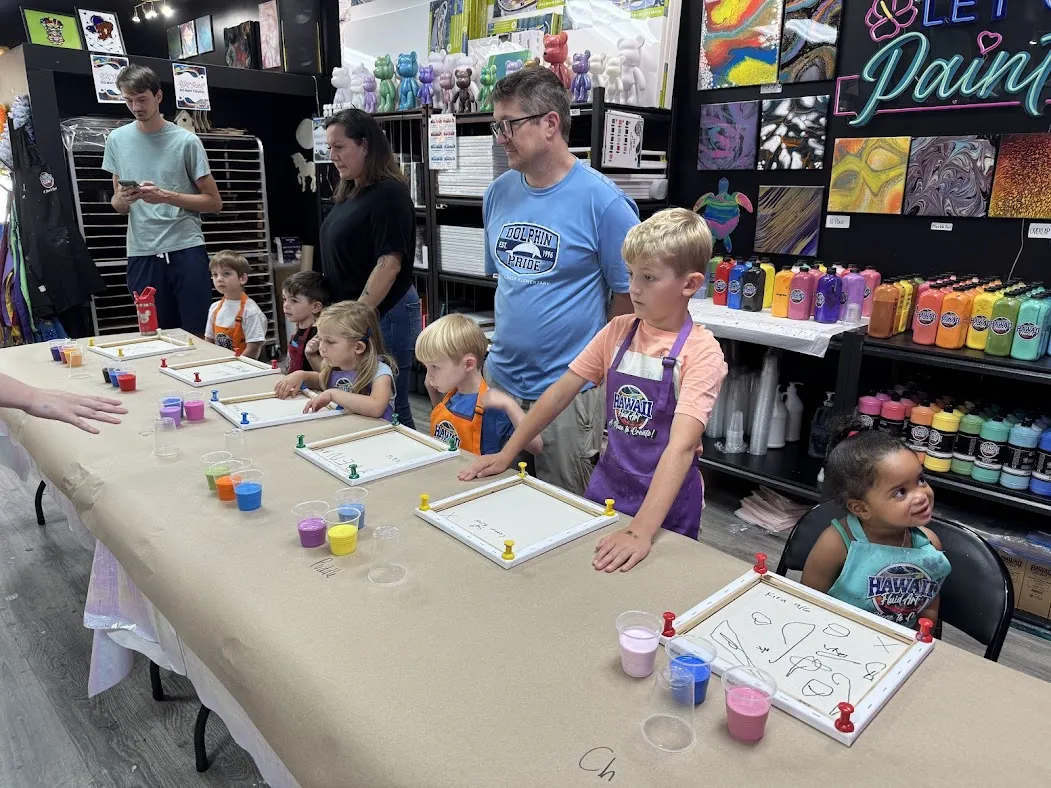 Kids creating colorful fluid art canvas at a birthday party in Johns Creek
