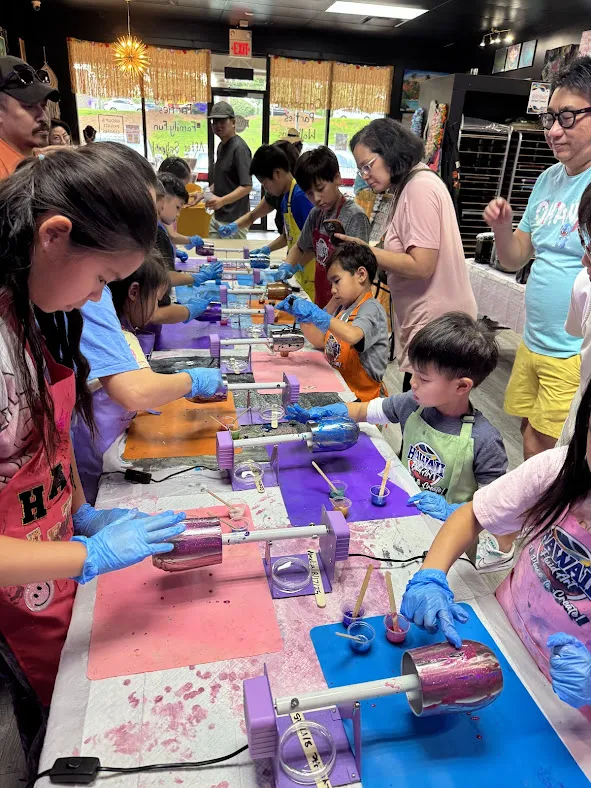 Kids designing custom resin tumblers at a creative birthday celebration in Johns Creek