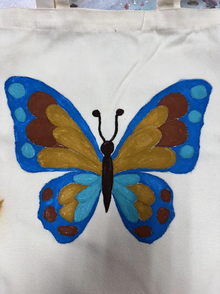 Children learning canvas painting techniques