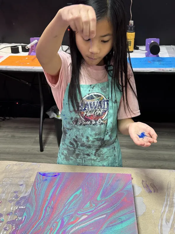 Homeschool students practicing intermediate fluid art pour techniques