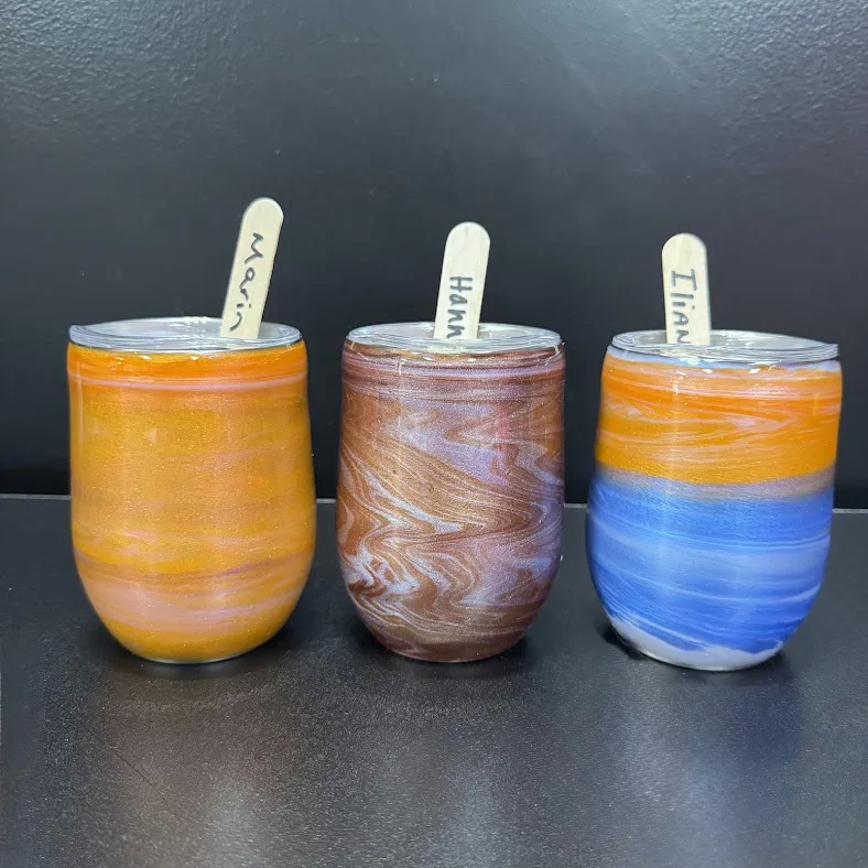 Child decorating a resin tumbler at Hawaii Fluid Art in Johns Creek