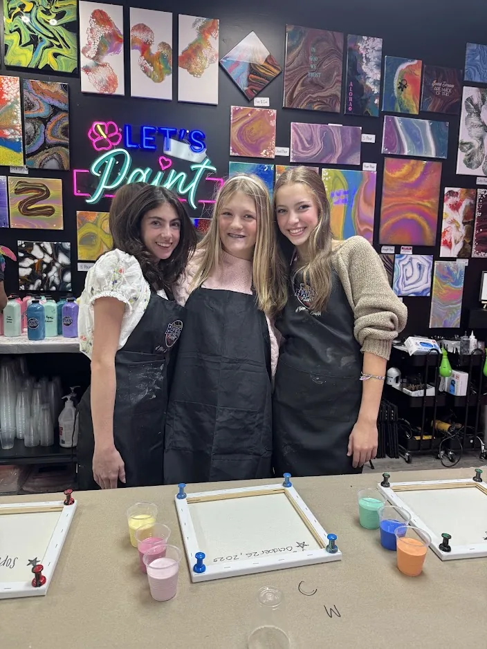 Three teens enjoying a fun social painting workshop in Johns Creek GA at Hawaii Fluid Art